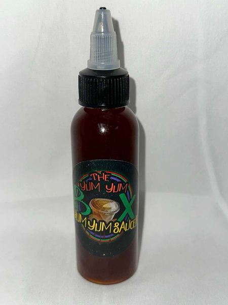 A small bottle of liquid is sitting on a white surface.