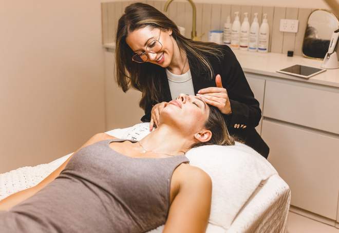 Tijan is assessing a client's face at Wollongong Skin Clinic