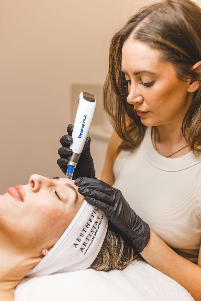 Tijan using a cutting-edge device to treat a client at Aesthetic Artistry Skin Clinic in Wollongong