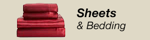 A stack of red sheets and bedding on a beige background.