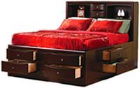 A bed with drawers underneath it and a headboard.