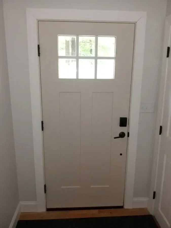 A white door with a small window in it