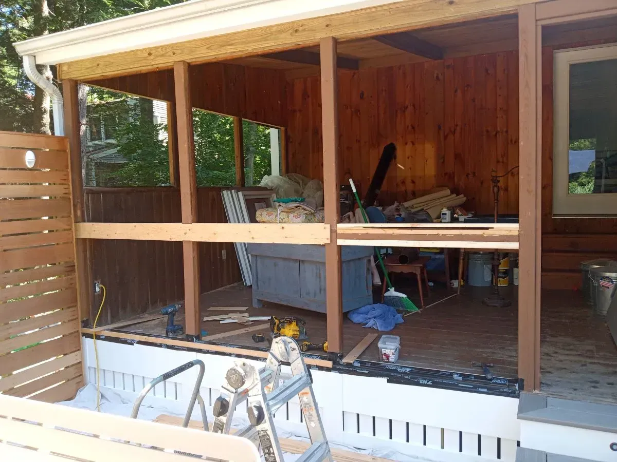 A wooden structure is being built next to a swimming pool.