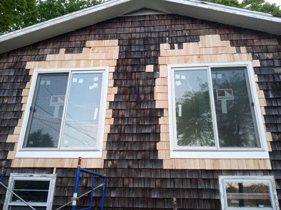 A house with wooden siding and sliding glass windows
