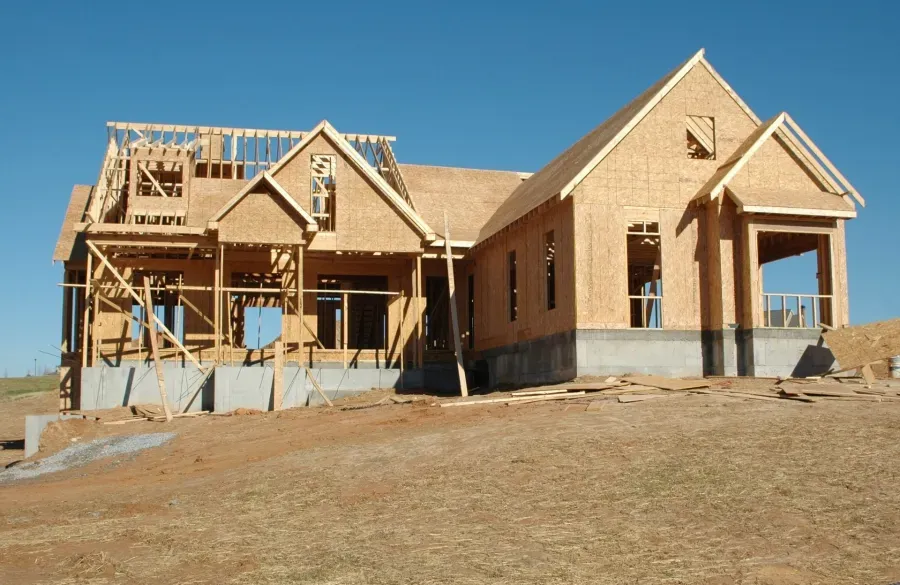 A house that is being built with a blue sky in the background