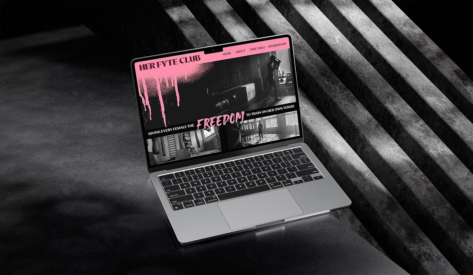 Laptop with a dark pink-and-black screen on a striped black background.