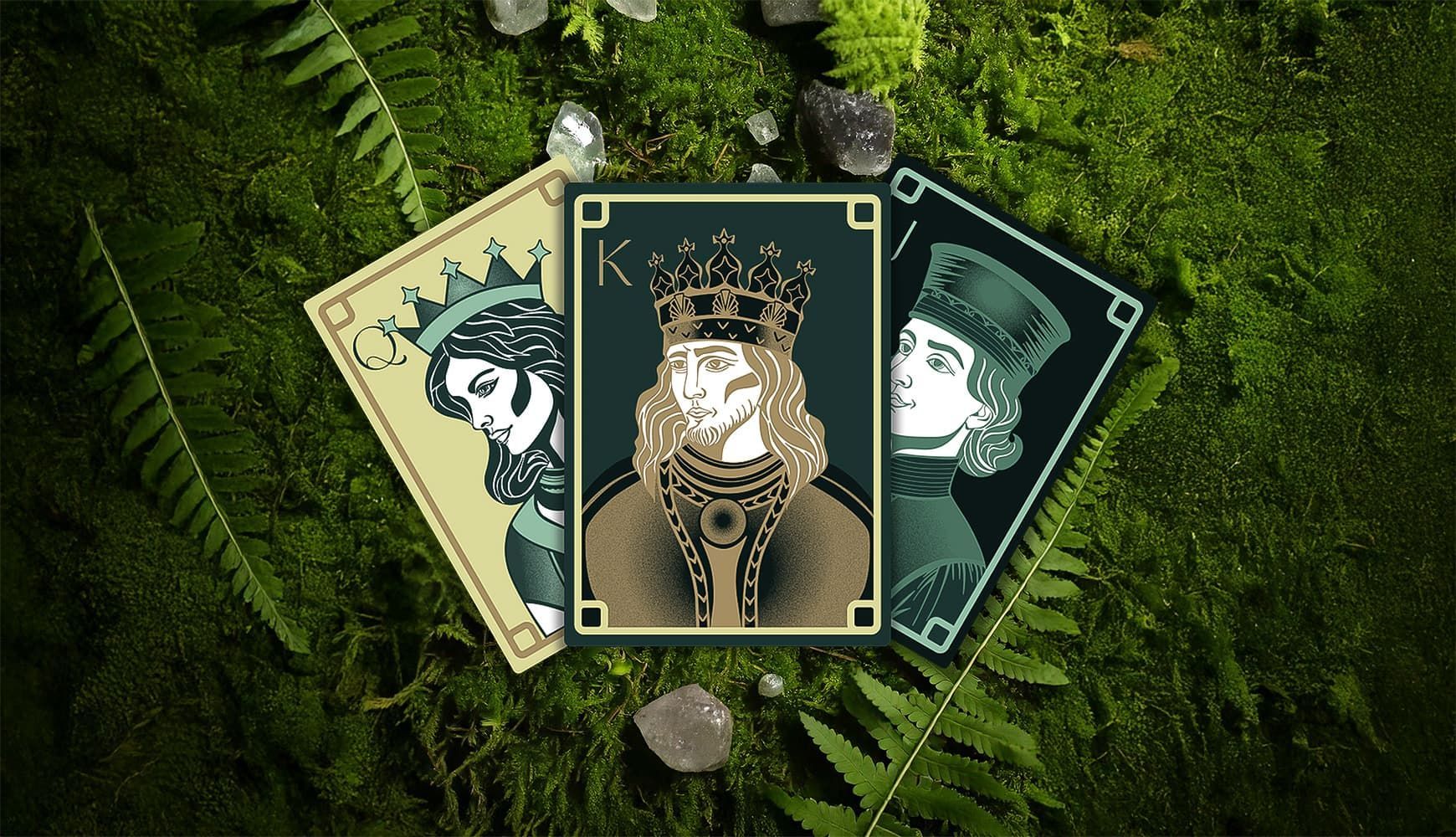 Three tarot-style cards on green grass, with a centered ornate card featuring a crowned figure.