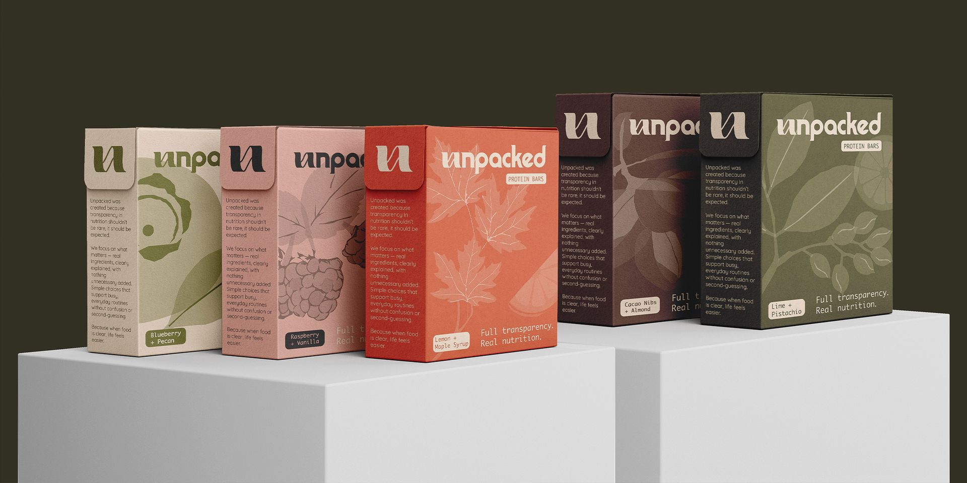Boxed beverage cartons in beige, pink, red, brown, and olive green displayed on white platforms