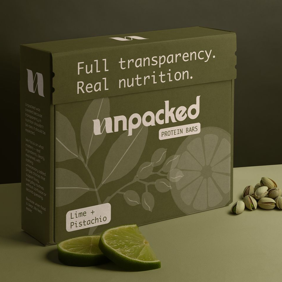 Green pistachio snack box with lime slice and pistachios on a beige background.