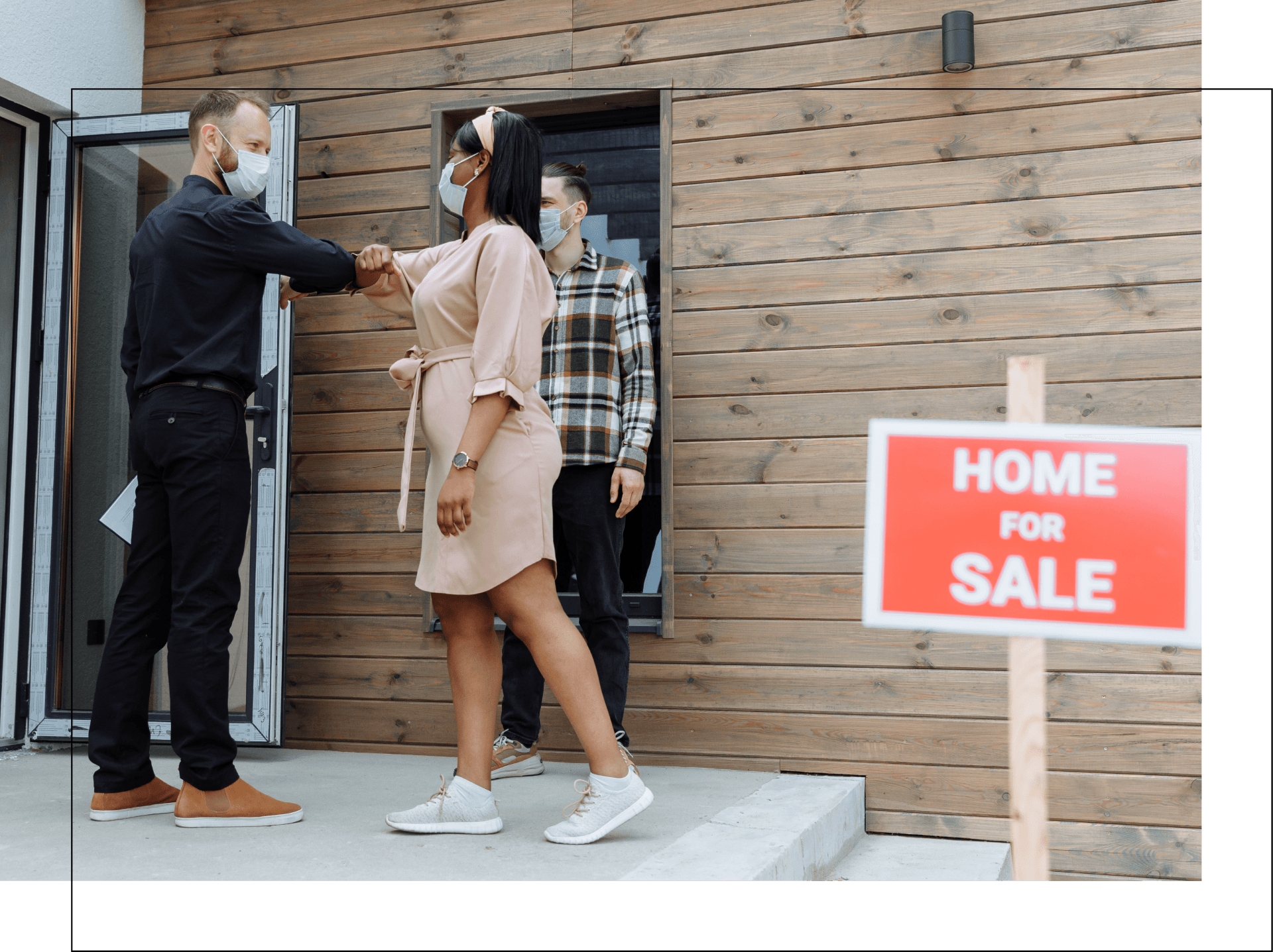 A man is shaking hands with a woman in front of a house for sale.