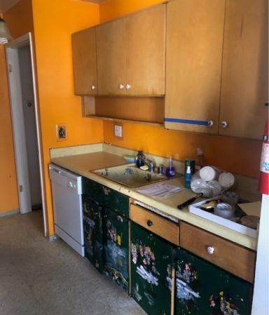 A kitchen with wooden cabinets and green drawers