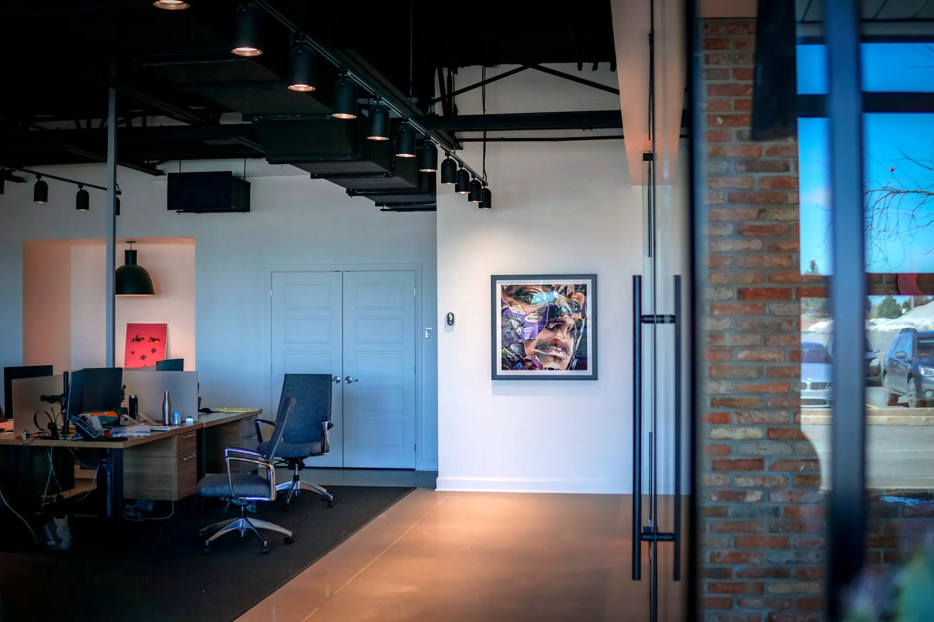 There is a picture on the wall in the office.