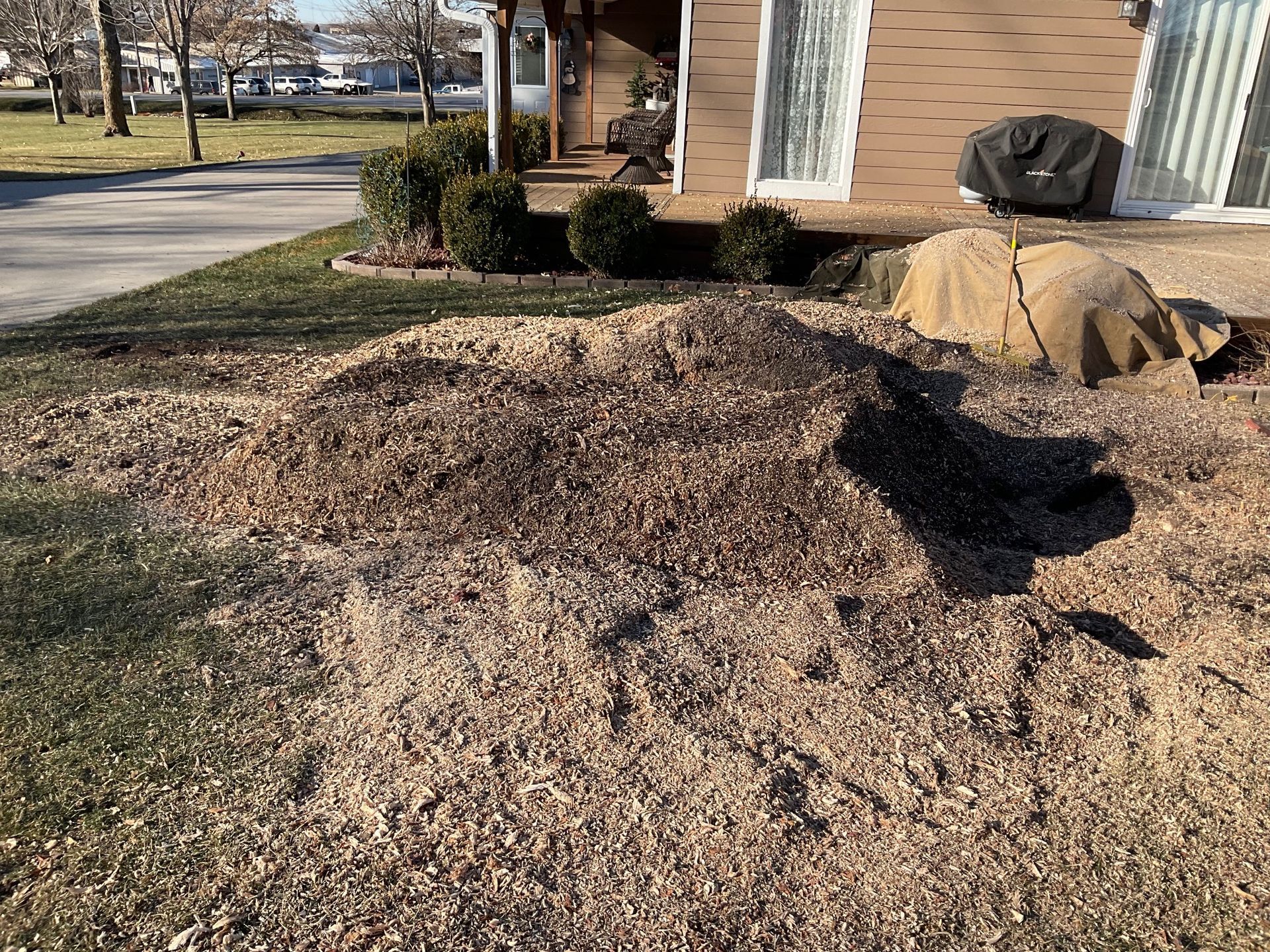 A pile of dirt is sitting in front of a house.