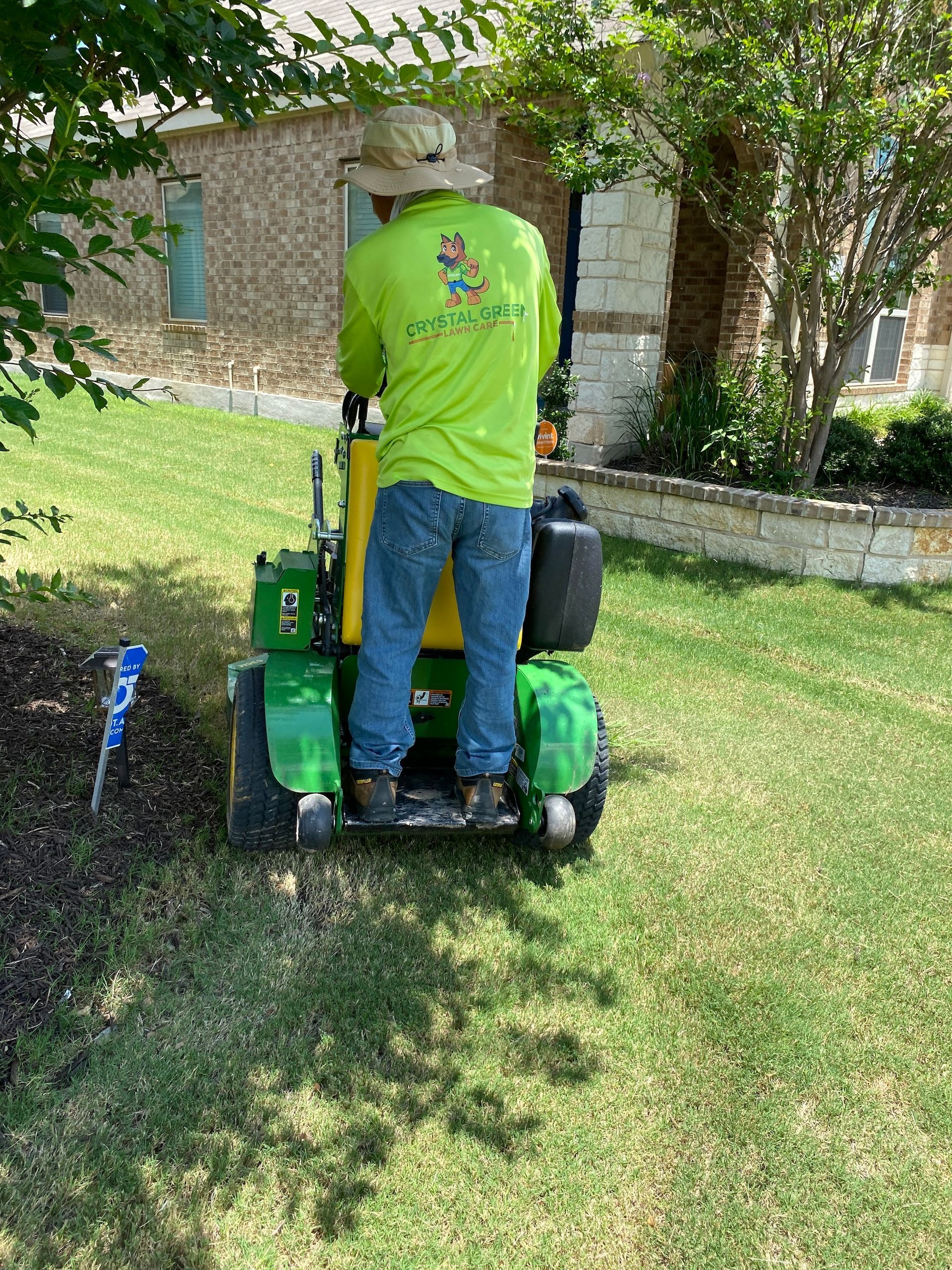 a man is riding a lawn mower on a lush green lawn .