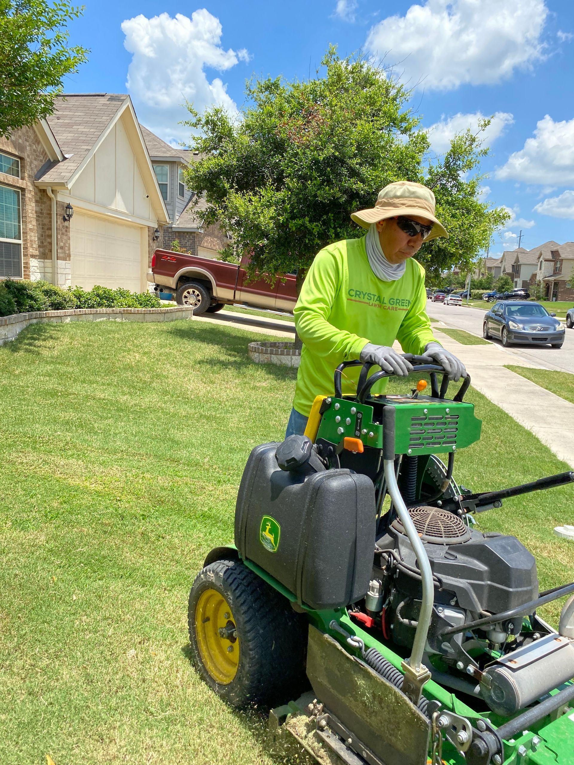 a man is riding a lawn mower on a lush green lawn .