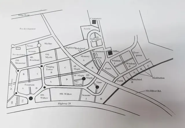 Black-and-white hand-drawn town map with roads, blocks, labels, and landmarks
