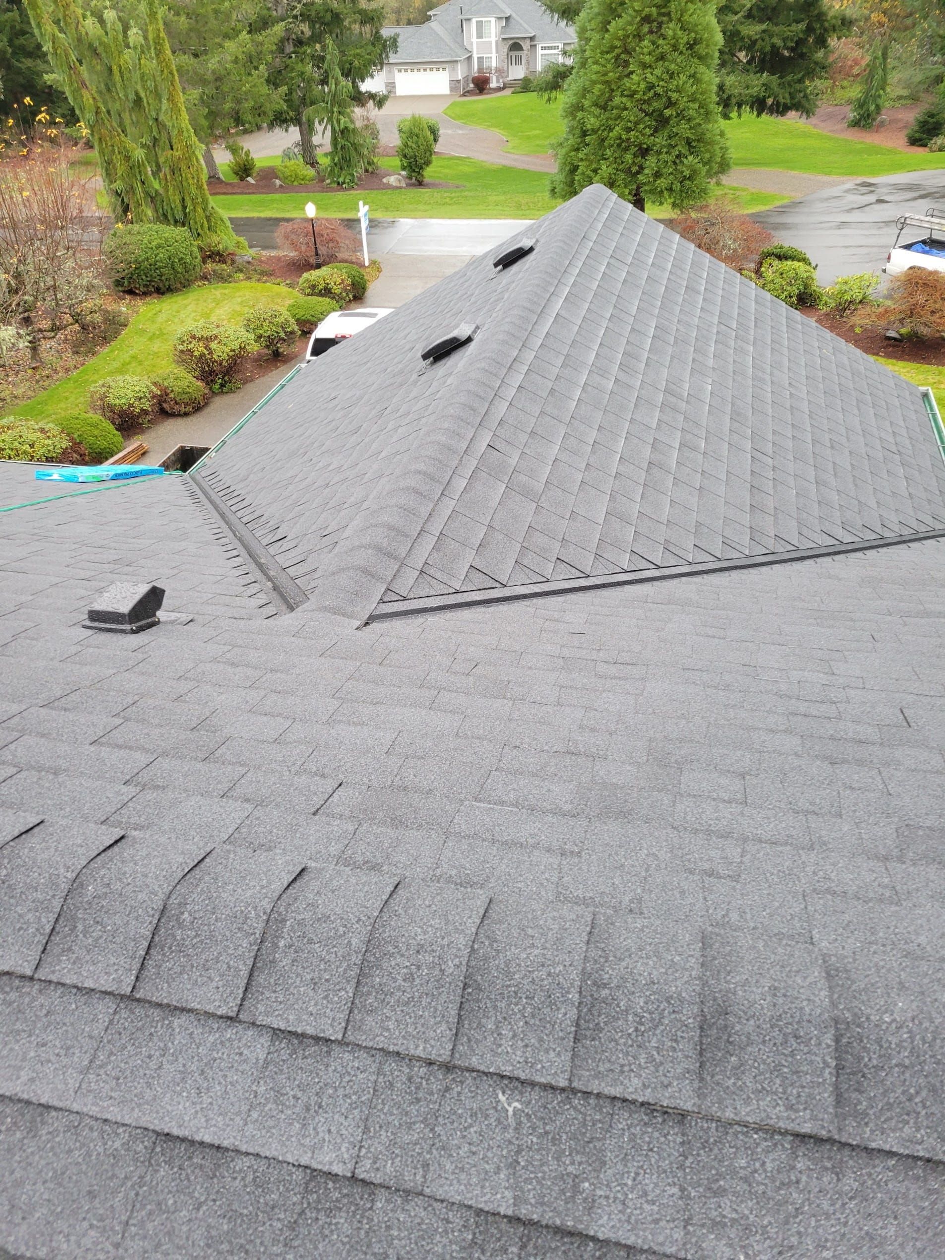 Completed asphalt shingle roof replacement with ventilation