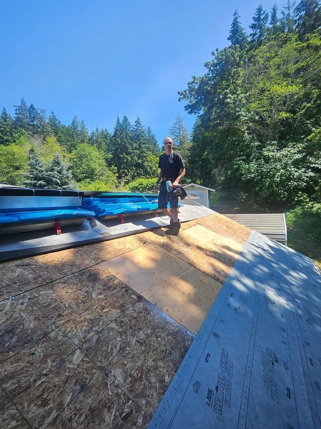 Scott Larsen inspecting a tarp-covered roof