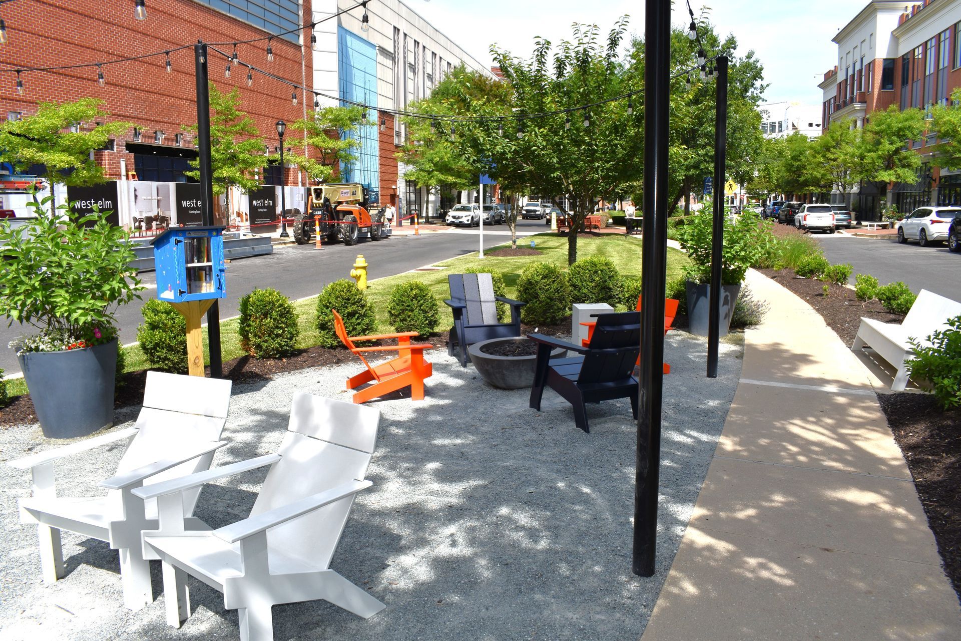 A public seating area located within a concrete lined island in a commercial/retail downtown location
