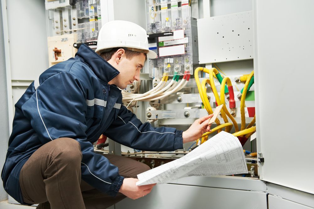 A Man in a Hard Hat is Working on an Electrical Box — Search Partners in Melbourne, VIC