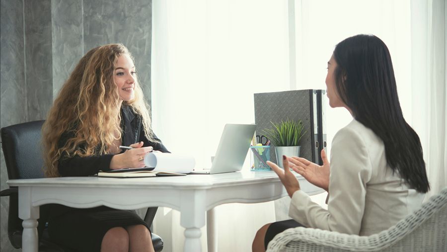Two Women Are Sitting at a Table Having a Job Interview — Search Partners in Brisbane, QLD