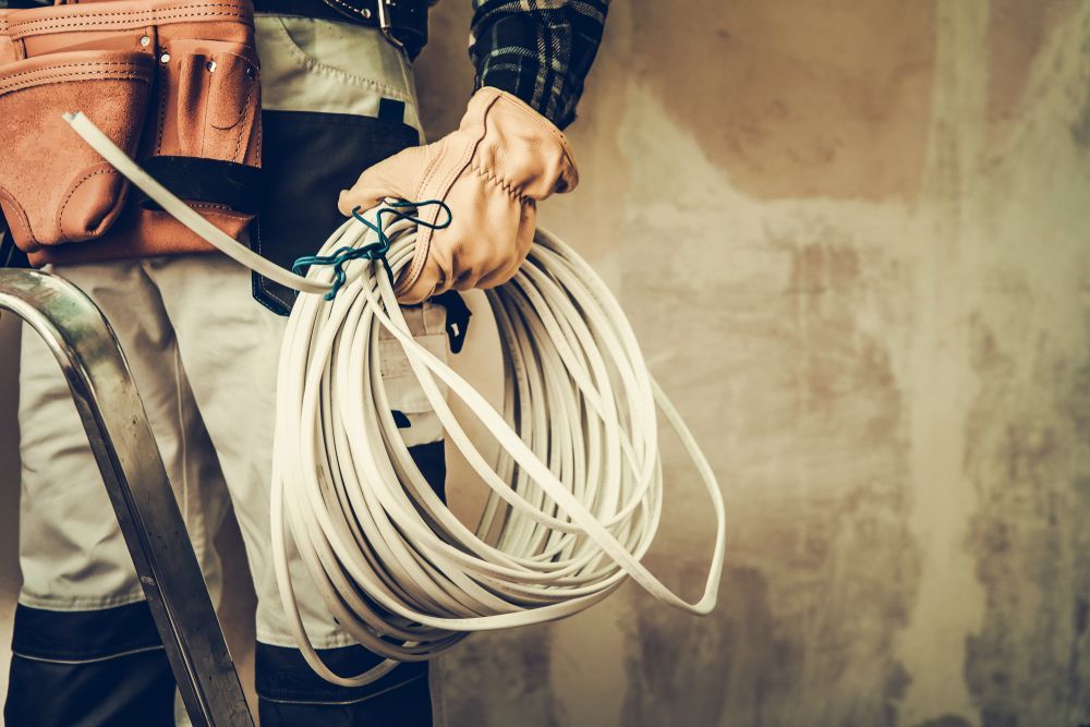 A Man is Holding a Roll of Wire in His Hands — Search Partners in Melbourne, VIC