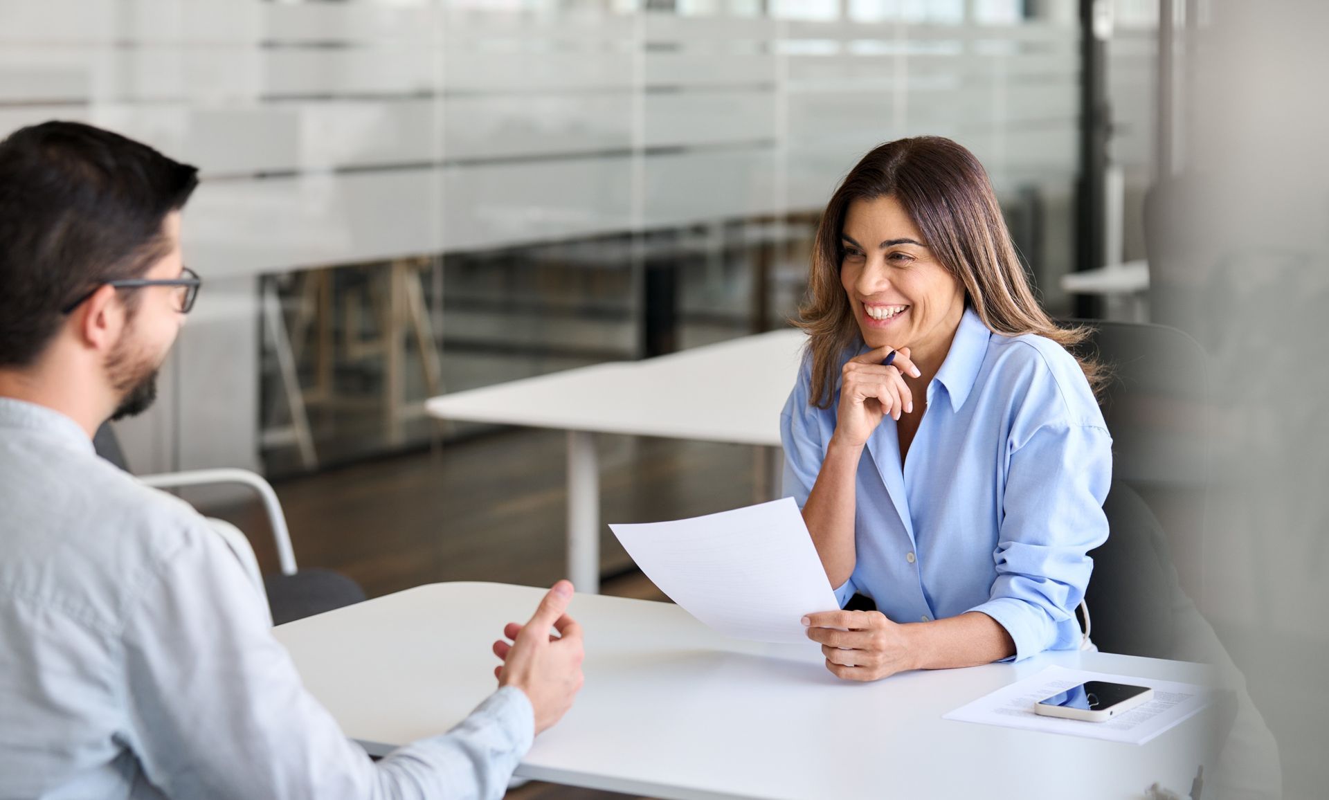 Woman in Blue Shirt Smiles During an Interview — Search Partners in Melbourne, VIC