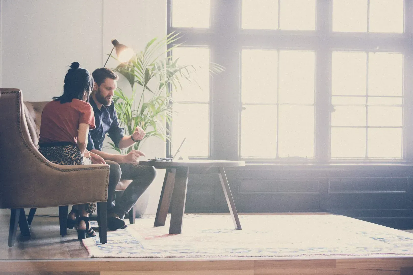 A Man and a Woman Are Sitting on a Couch in a Living Room — Search Partners in Melbourne, VIC