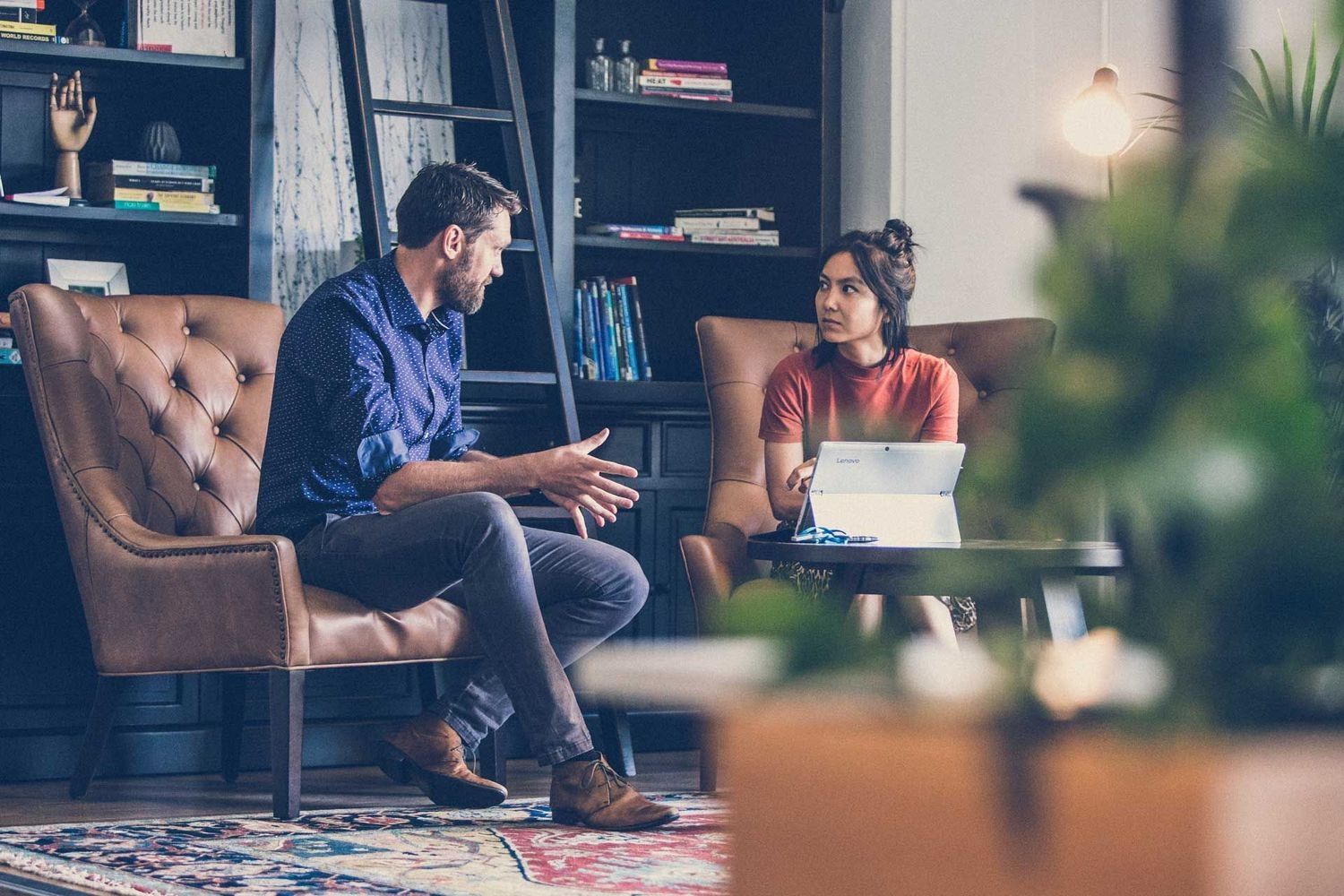 A Man and a Woman Are Sitting on a Couch Talking to Each Other — Search Partners in Adelaide, SA