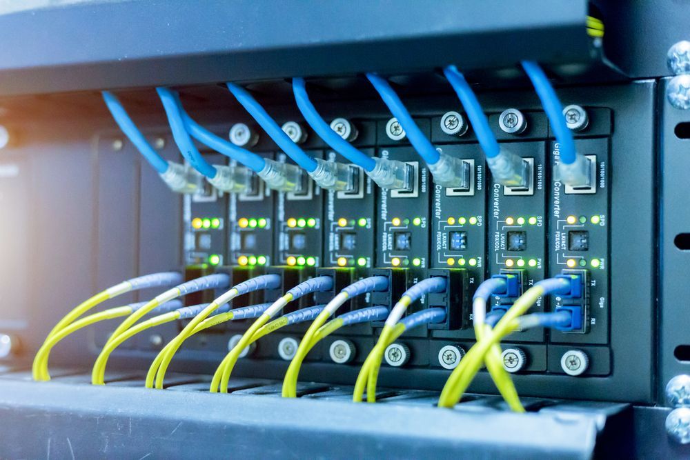 Network Server Rack With Blue and Yellow Ethernet Cables — Search Partners in Melbourne, VIC