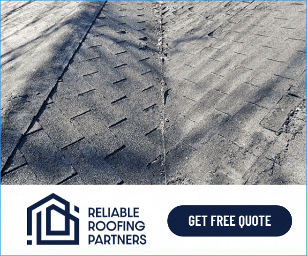 Close-up of worn asphalt shingles on a roof. A