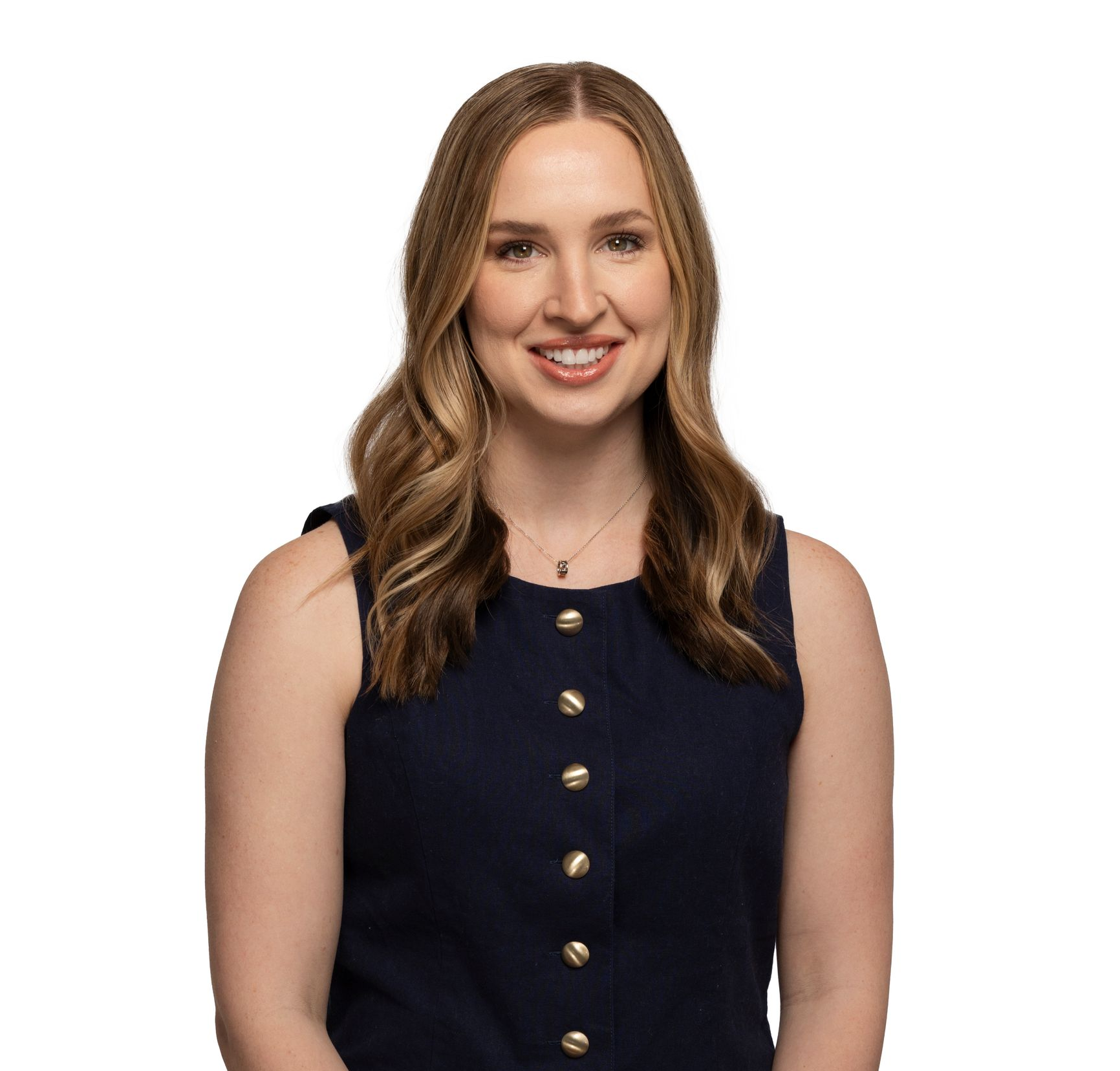 Smiling woman in a navy sleeveless top against a white background