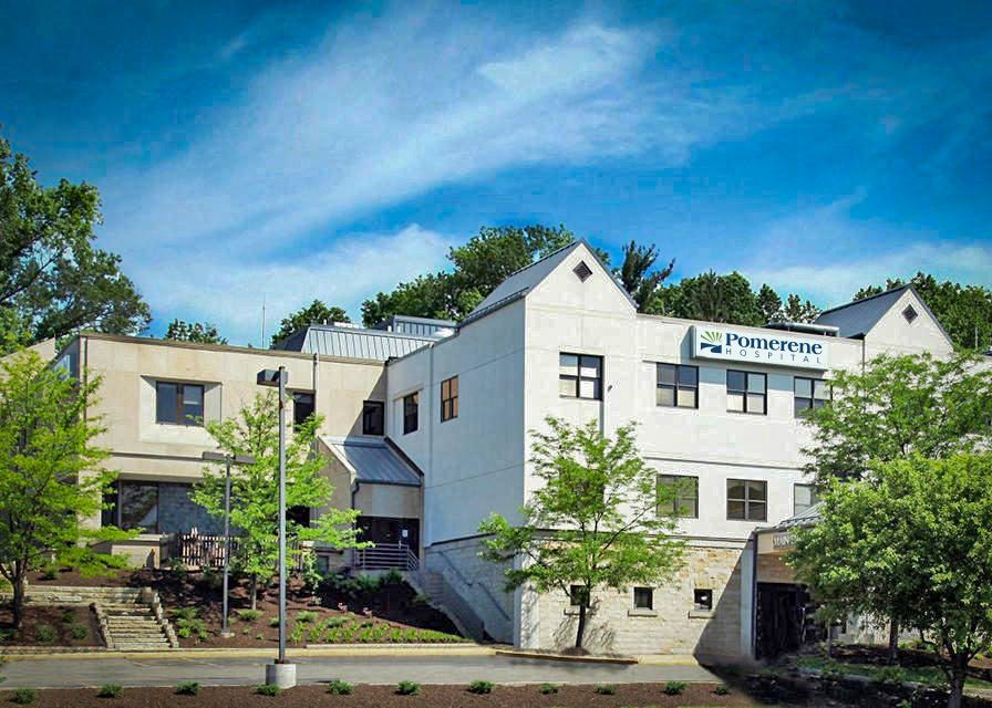 A light-colored building with a sign reading