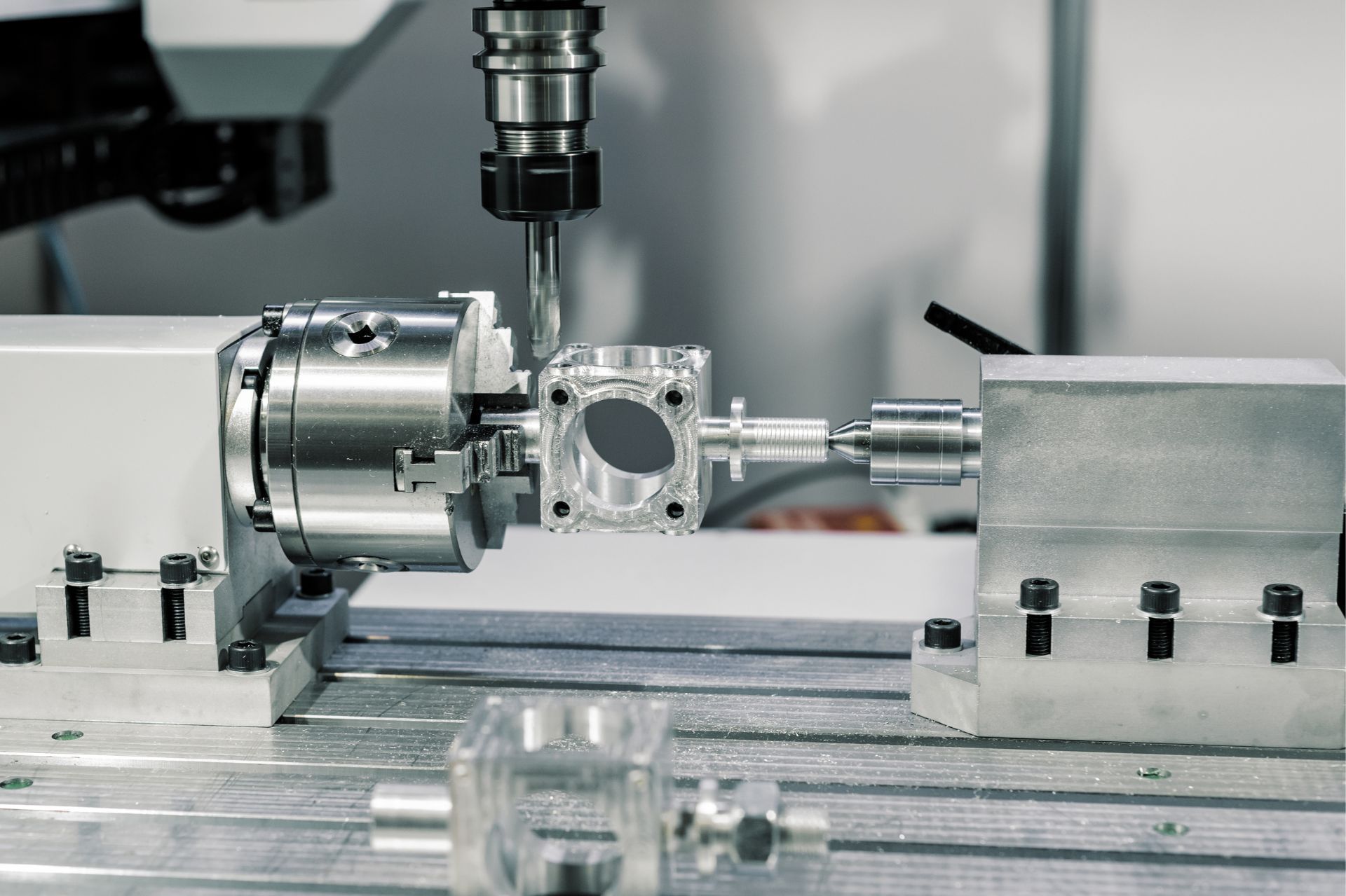 CNC machine milling a metal workpiece in a precision industrial setup