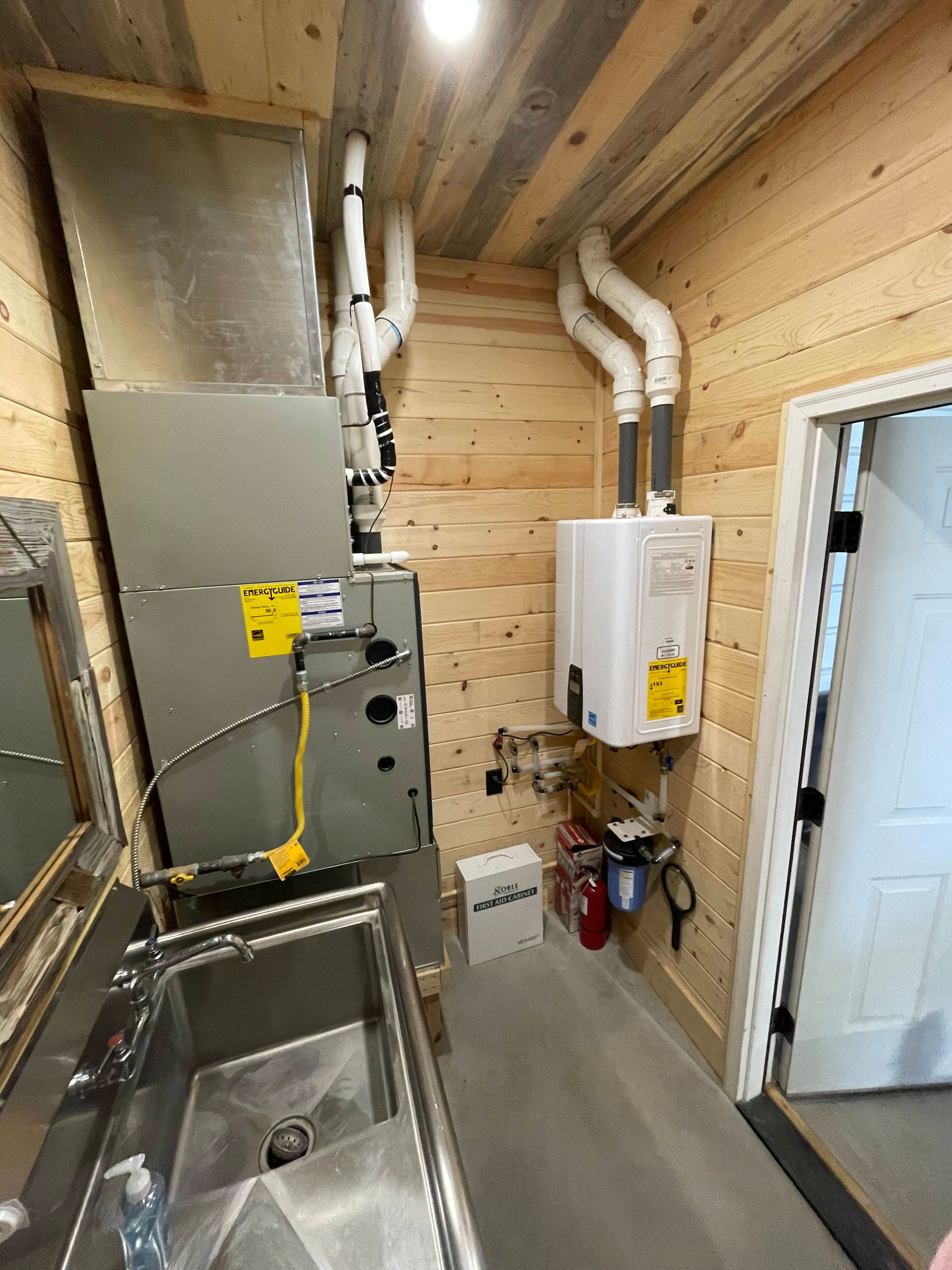A bathroom with a sink and a heater on the wall.