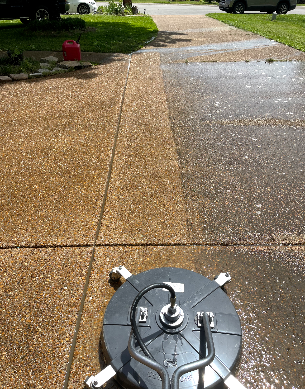 A person is using a high pressure washer to clean a tiled floor.