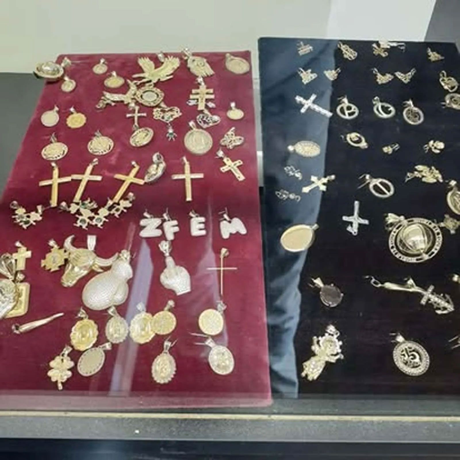 A display of religious jewelry including crosses and the word zfem