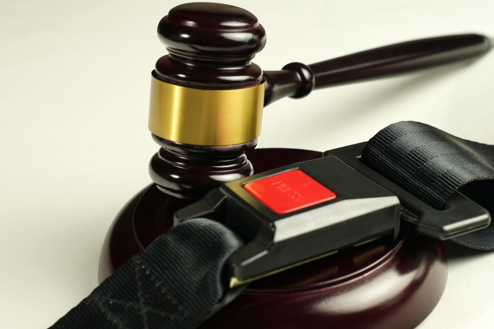 Judge’s gavel with a court seal and black eyegavel strap on a white background