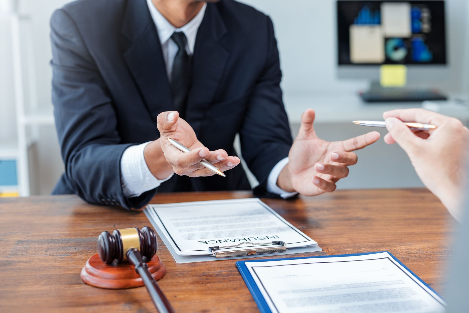 Car accident injury attorney reviewing an insurance claim document with a client.