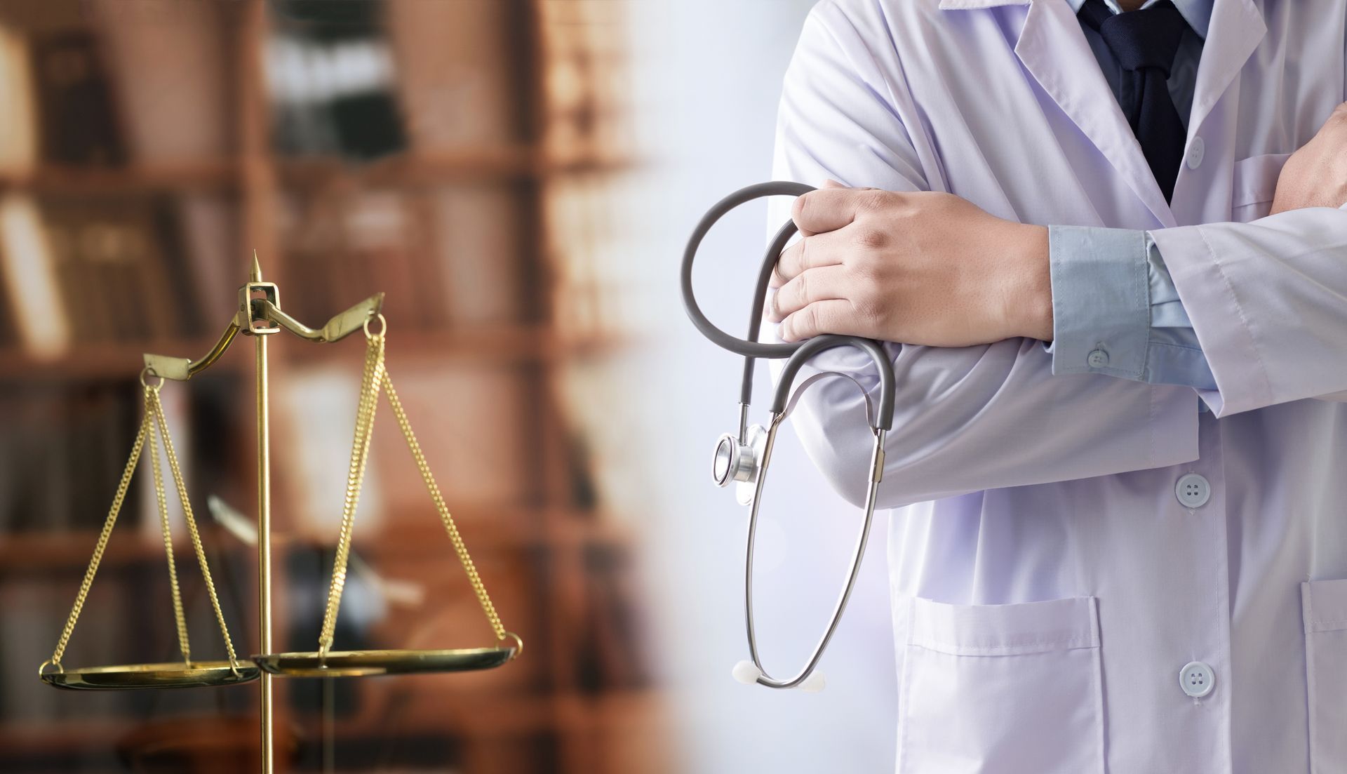 Law scales beside a doctor holding a stethoscope in a blurred office setting