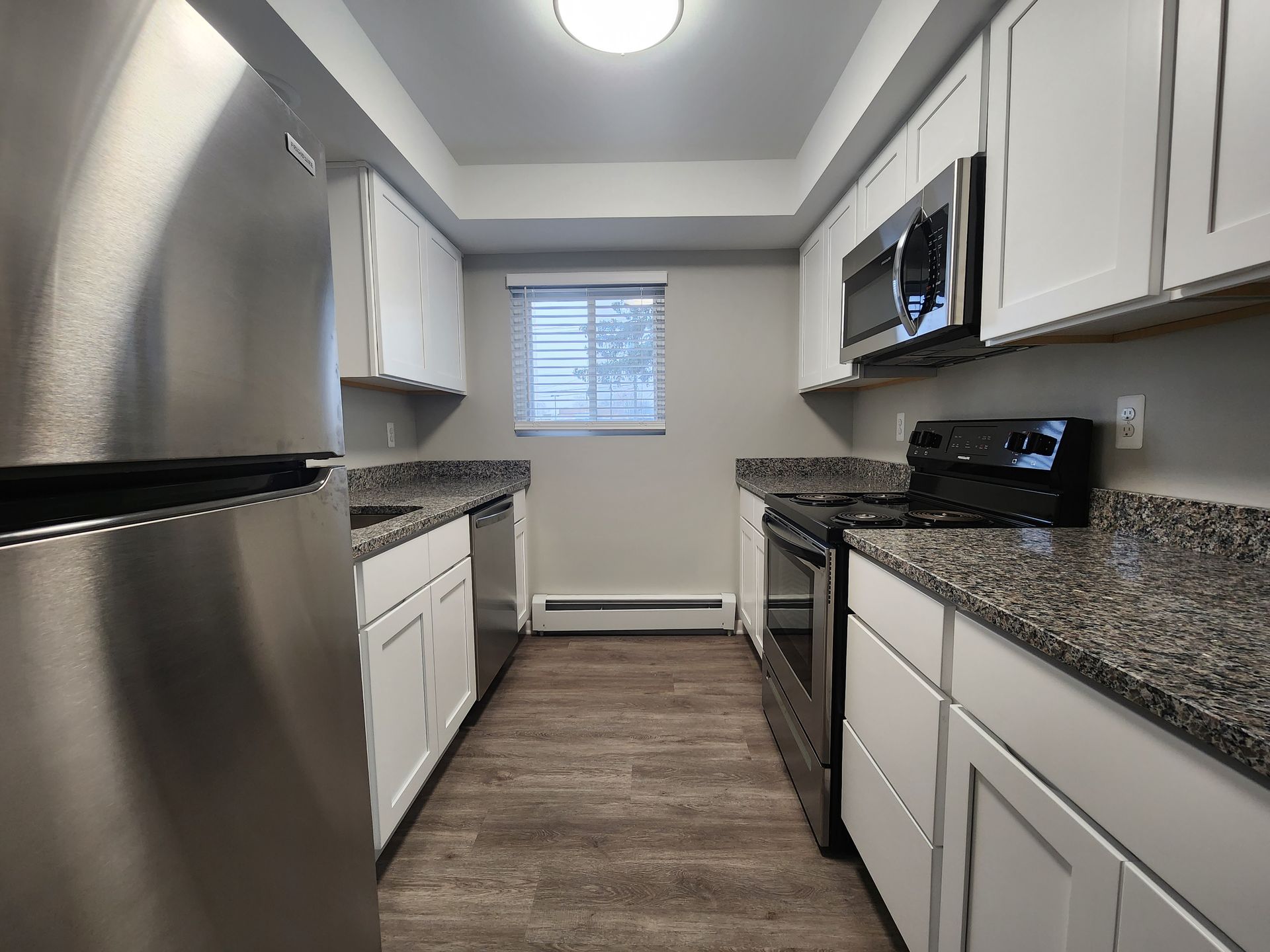 A kitchen with stainless steel appliances and granite counter tops