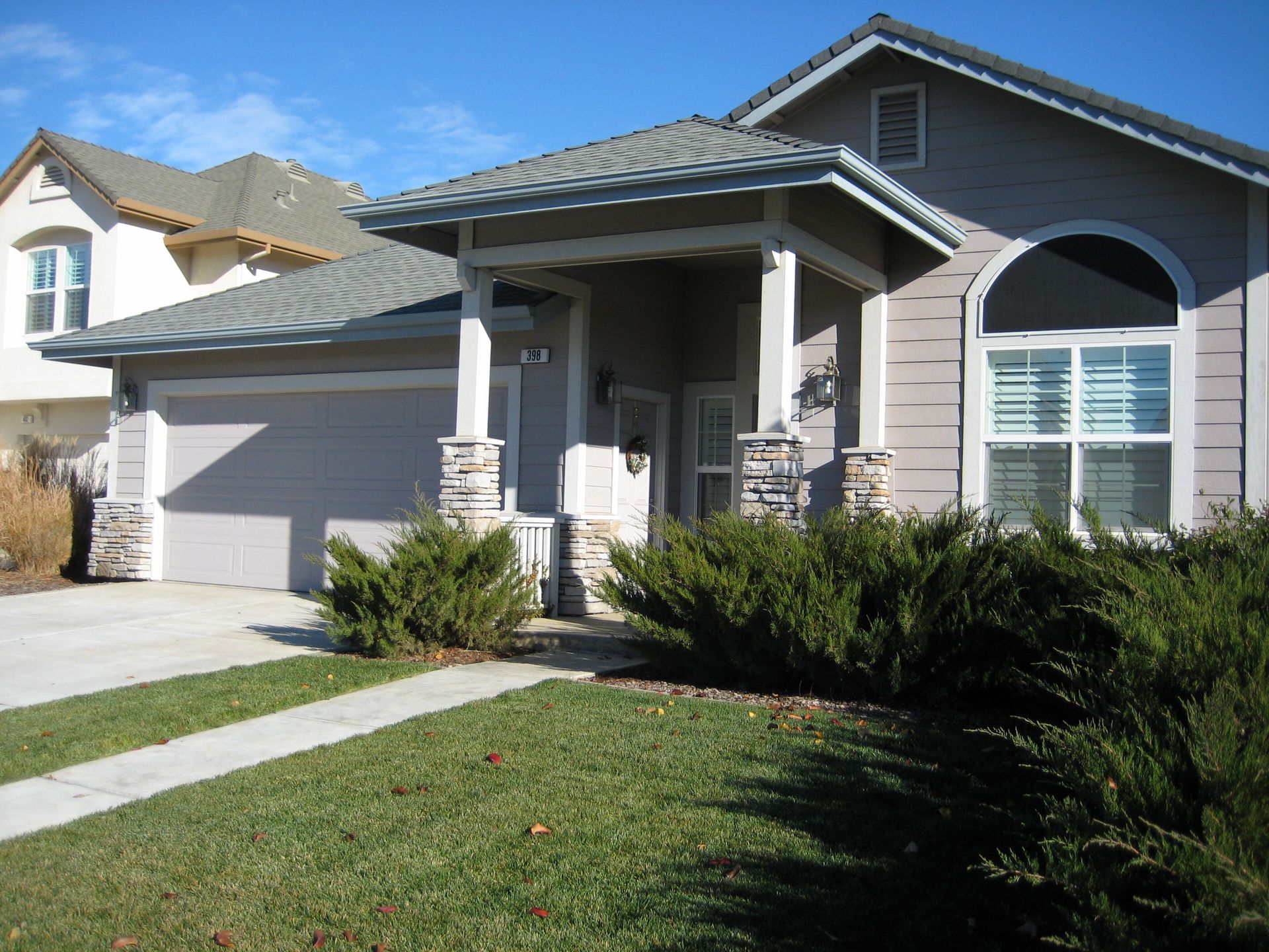 a house with a large porch and a large garage