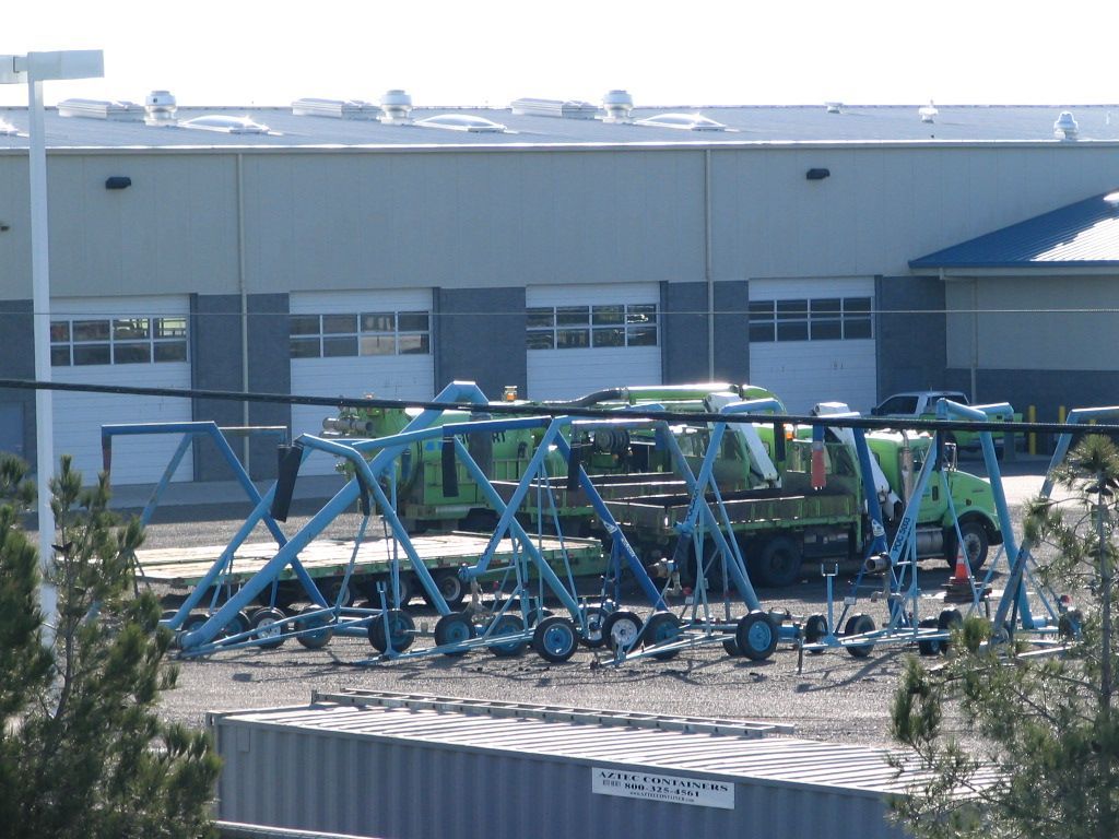 a green truck is parked in front of a building