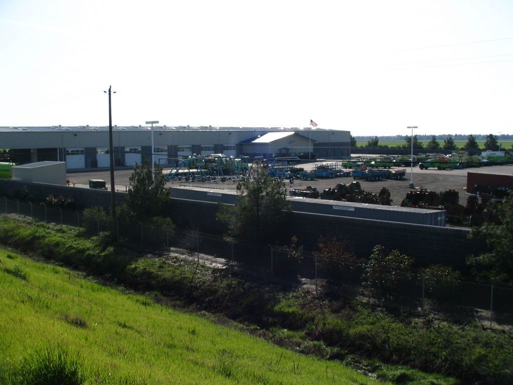 a large building with a lot of trucks parked in front of it