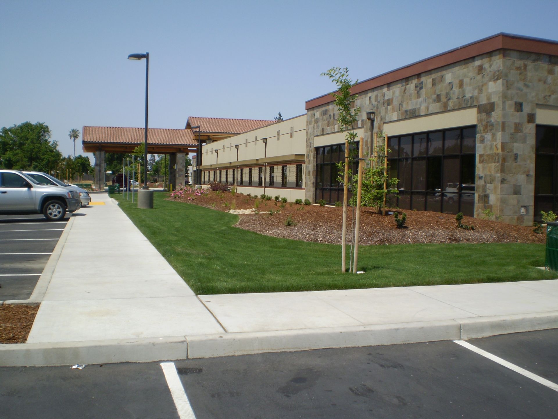 a parking lot with cars parked in front of a large building