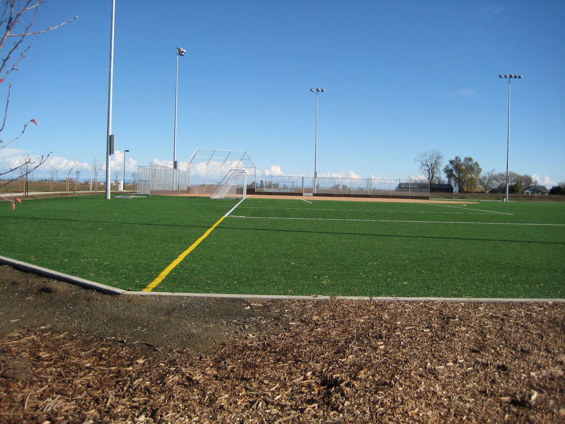 a soccer field with a yellow line in the middle