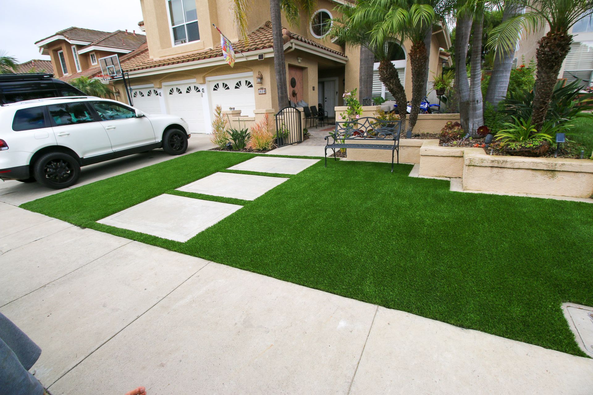 artificial grass in back yard with planters