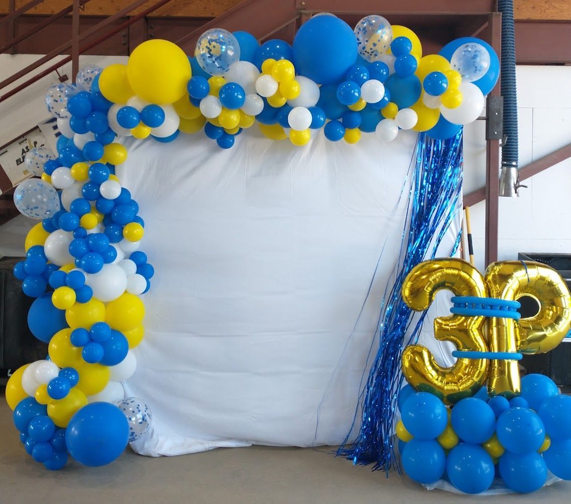 A blue and yellow balloon arch with the number 3 on it