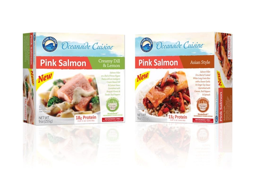 Two cartons of pink salmon are sitting next to each other on a table.