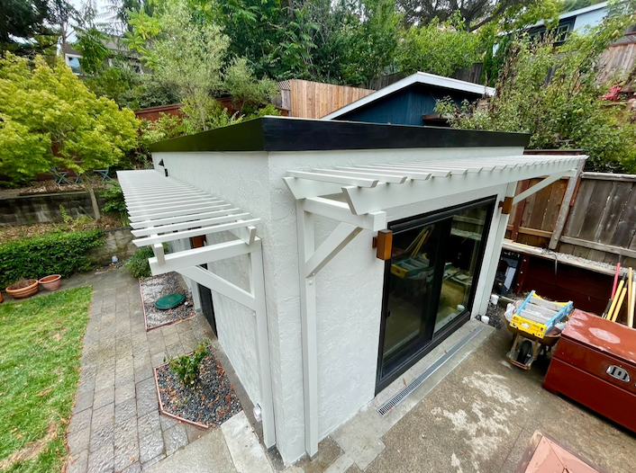 A white house with a black garage door